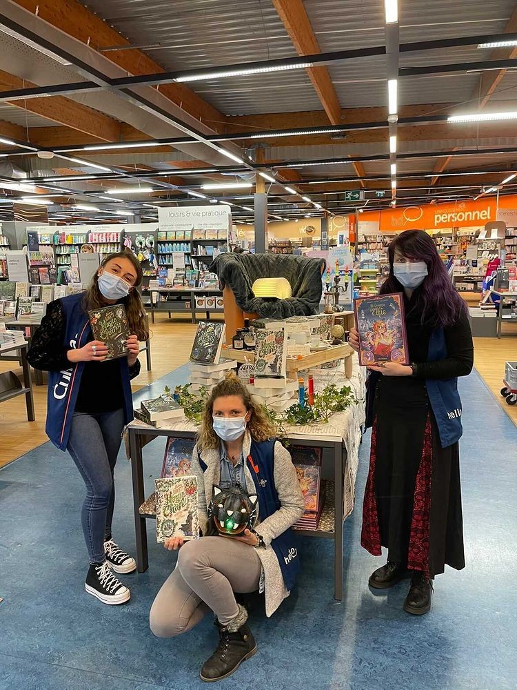 Trois libraires de Cultura présentent Magic Charly et Le Grimoire d’Elfie devant une table de présentation
